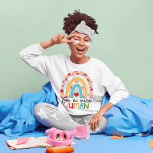Be A Nice Human Sweatshirt Boho Rainbow Sweatshirt. Un proyecto de Diseño, Publicidad, Moda, Diseño de moda y e-commerce de teeducate - 25.11.2021