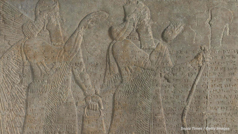 Detail of an Assyrian wall relief featuring figures in fringed clothing