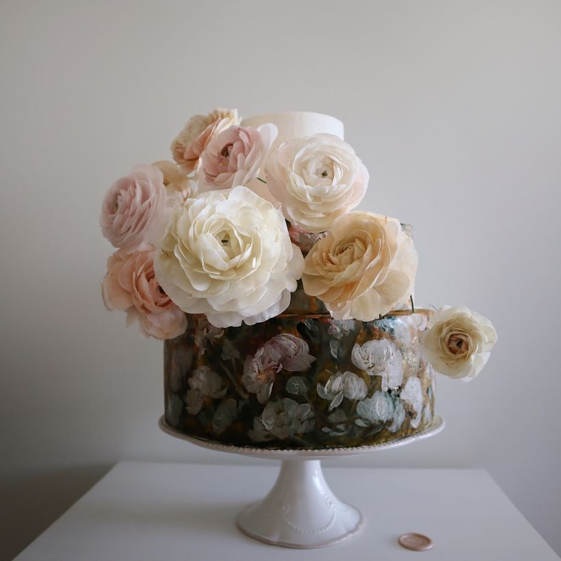 Hand-painted flowers on a 3-tiered cake along with handcrafted wafer flowers