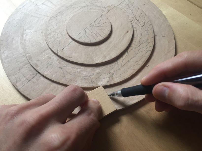 Drawing all the line by hand directly onto the wood.