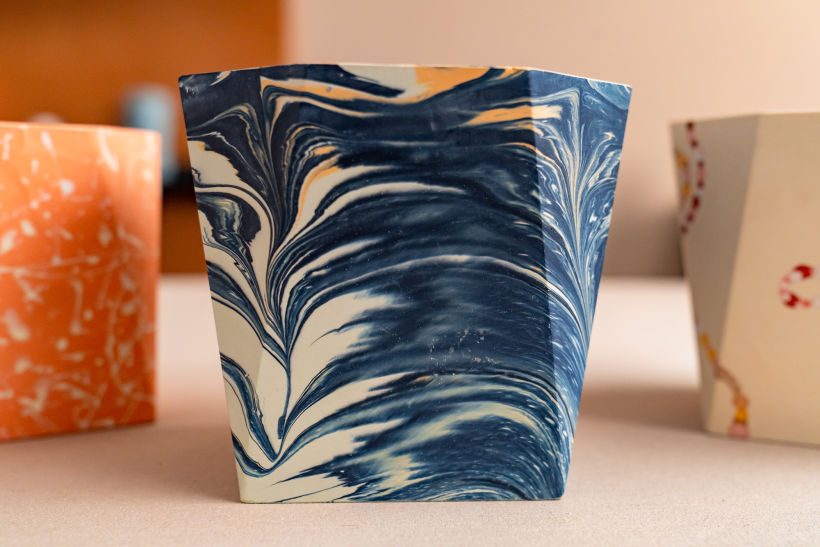 A PLANTER CAST IN MARBLED ACRYLIC RESIN