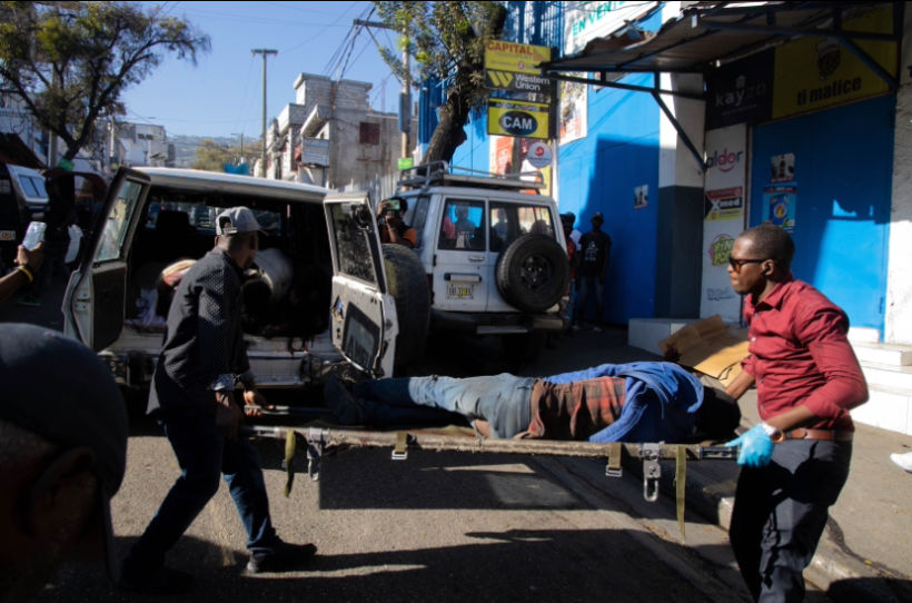 paramedics removing a man shot by individuals did not identify in Port-au-Prince, Haiti, 2024. (Photo/Pierre Marckinson)